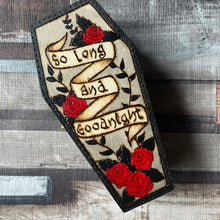 Load image into Gallery viewer, Wooden box in a coffin shape, with the words So long and Goodnight on a banner, red roses and black foliage 