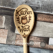 Load image into Gallery viewer, 30cm wooden spoon with kitchen witch design, including a cauldron and leaves